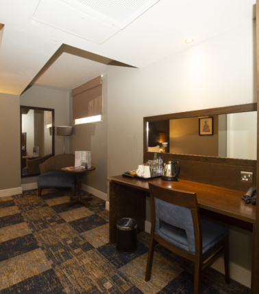 The John Russell Fox hotel room desk and seating area