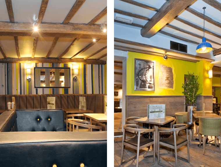 Dining booths and seating with wooden flooring inside The Kings Head Hotel pub