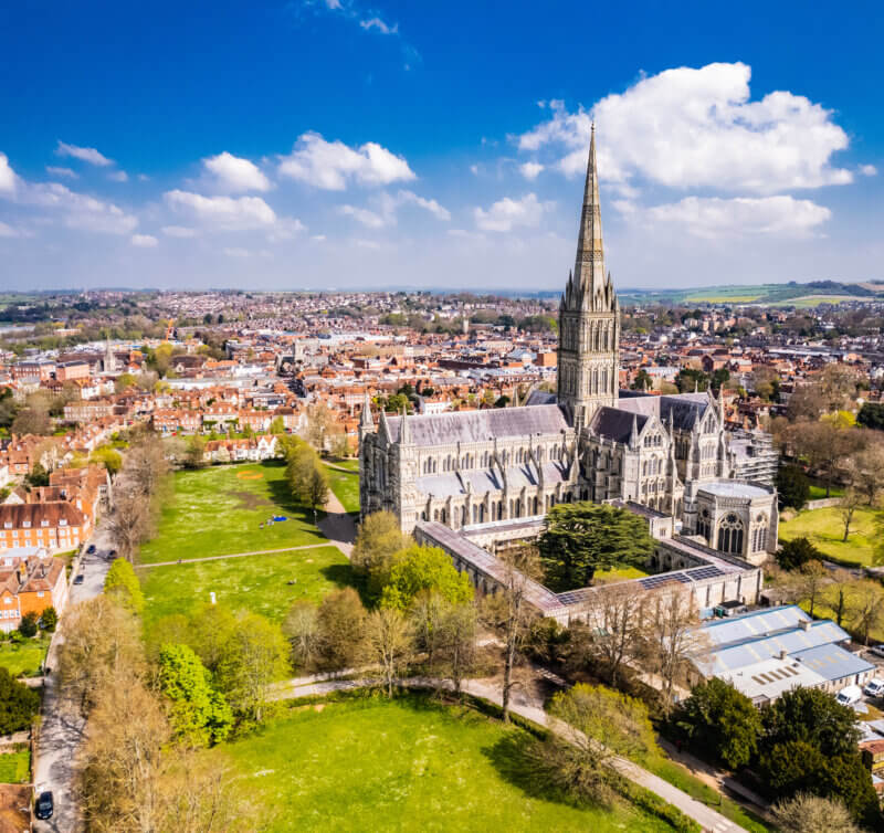 Aerial shot of Salisbury Cathedral under a sunny blue sky