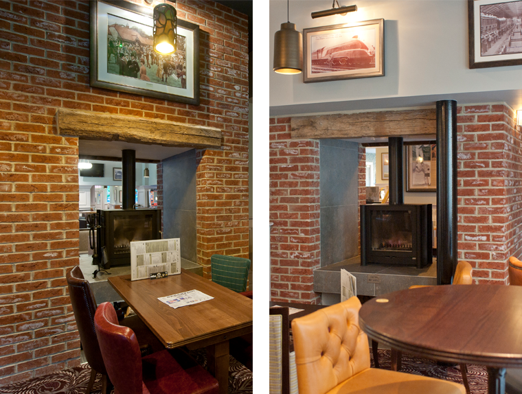 Dining tables and chairs next to fireplace at The Red Lion pub