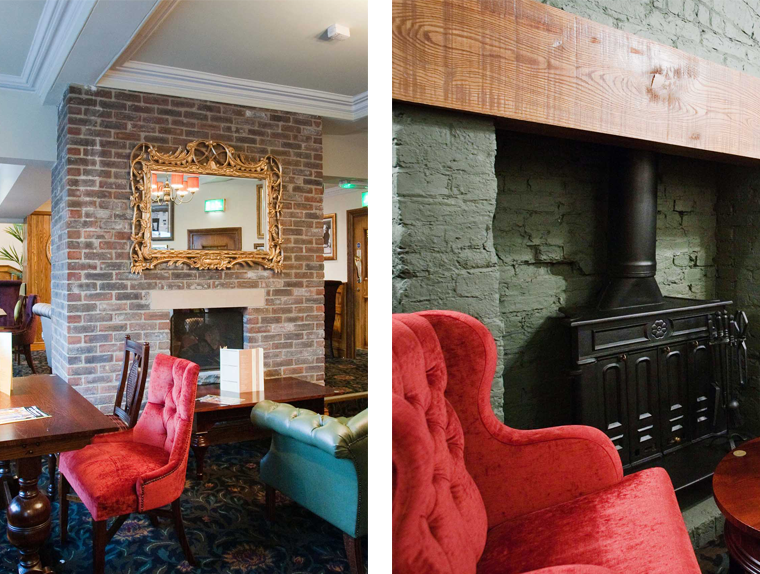 Dining table and red chairs next to wood burning stove in The Unicorn Hotel pub