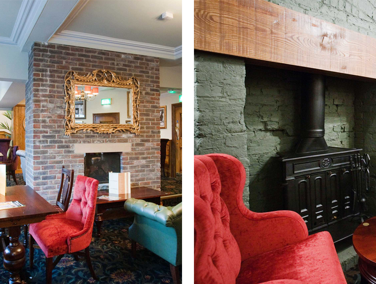 Dining table and red chairs next to wood burning stove in The Unicorn Hotel pub